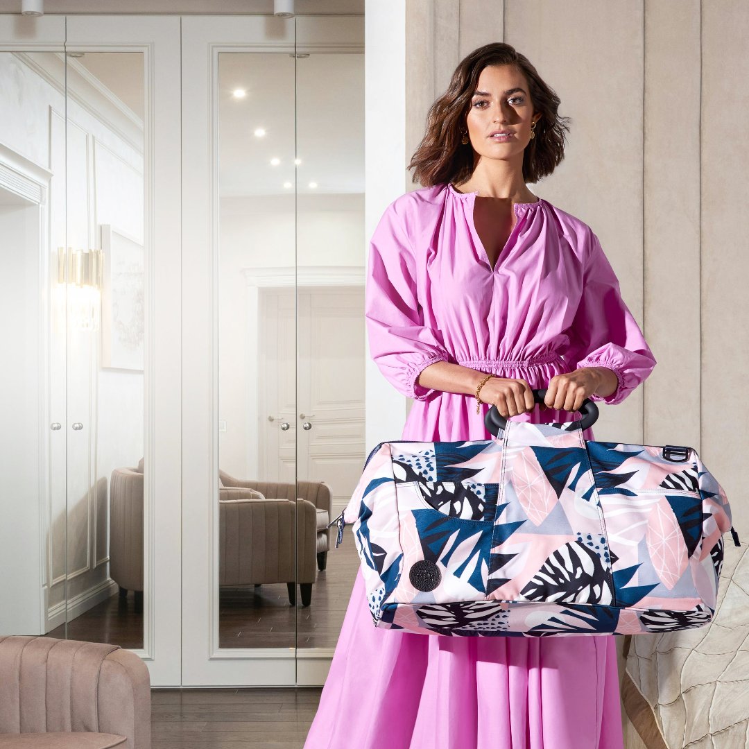 woman in pink dress standing in a hotel room