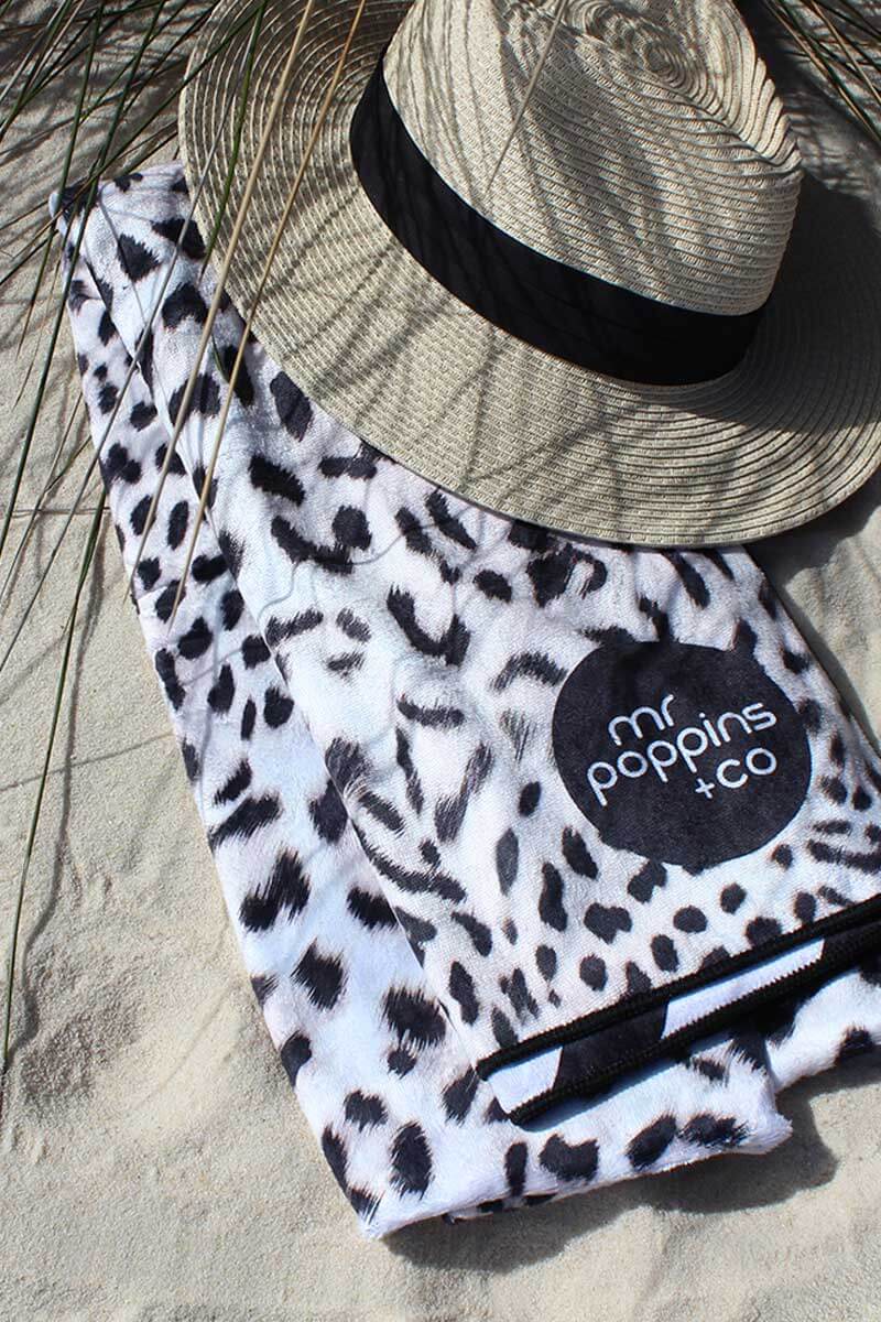 sand free beach towel in cheetah print with black and white diagonal stripes on back