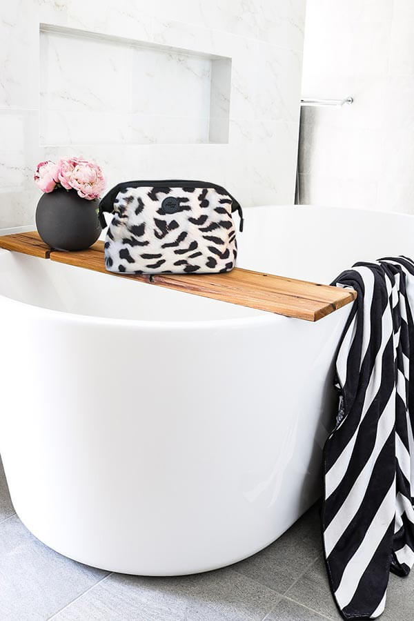 Cheetah toiletry bag in bathroom with striped towel